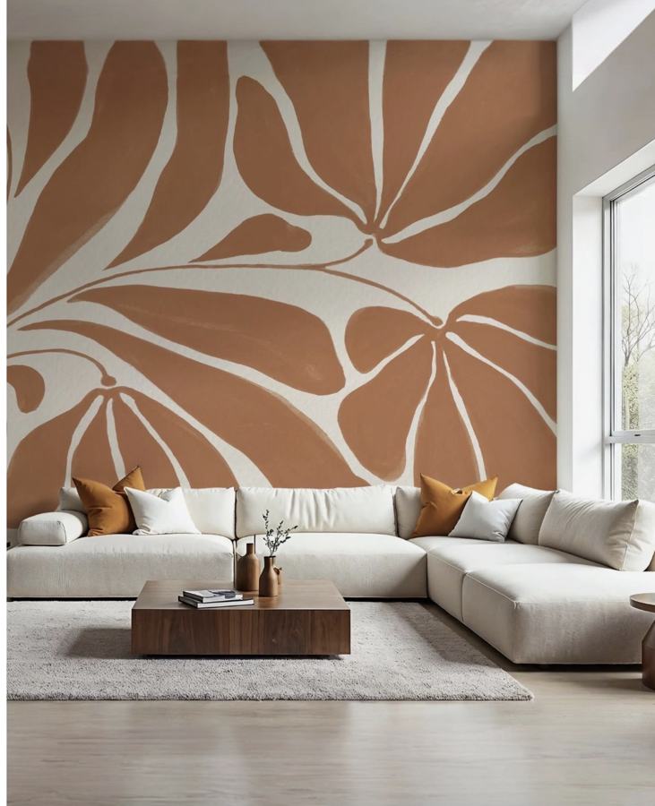 Parete del soggiorno dipinta con grandi foglie color terracotta